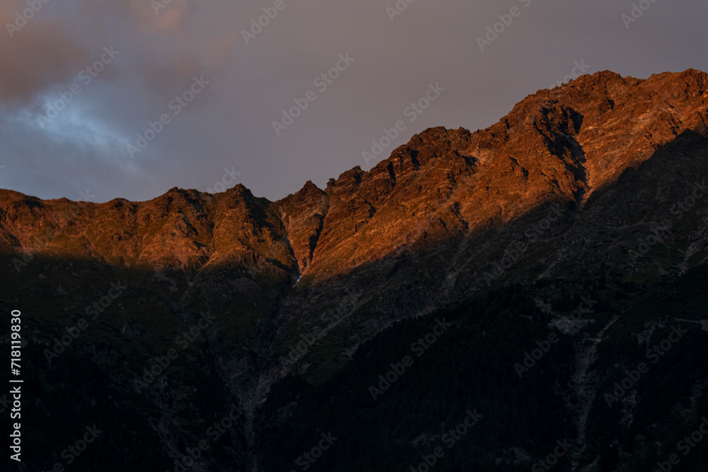 Obraz premium Mountain rocky face in sunset in the Alps