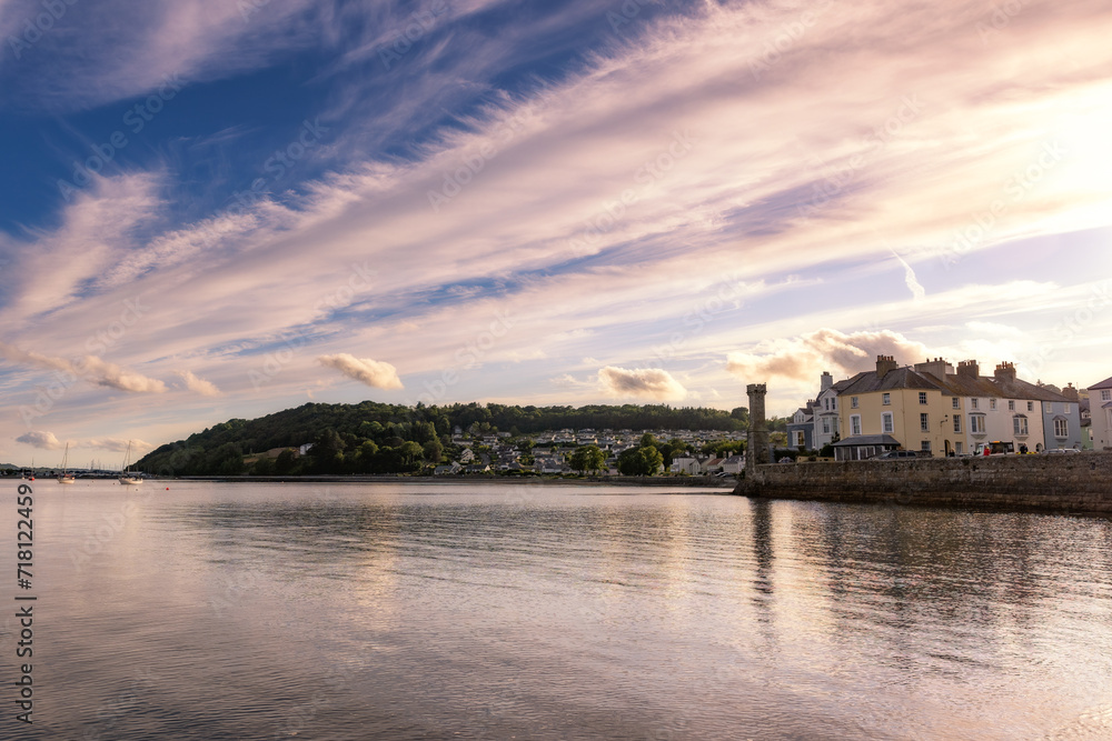 Sunset sky reflecting in a bay surrounded by a small seaside village. Menai Strain and Beaumaris North Wales