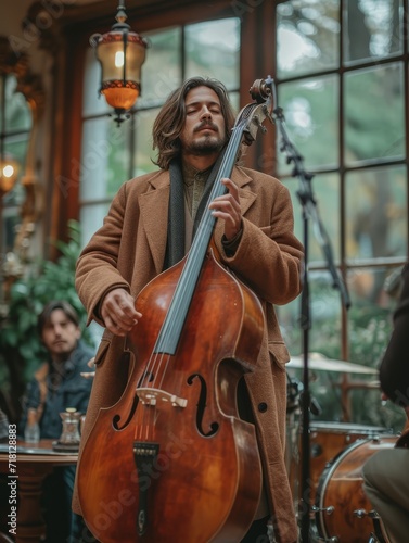 A dexterous cellist in formal attire expertly plays his double bass, captivating his audience with the soulful sounds of classical music