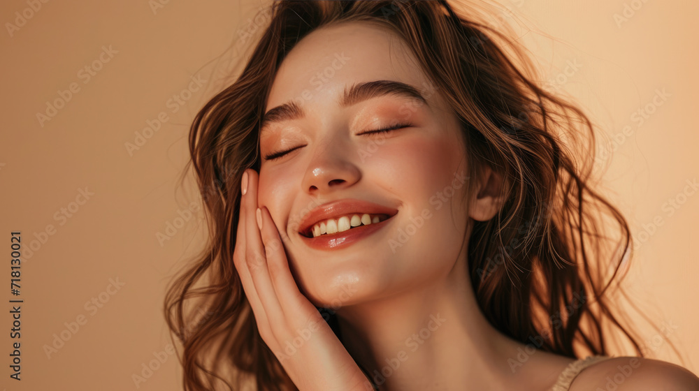 Smiling woman with a hand gently touching her face, displaying clear skin and a joyful expression. Smiling woman with a hand gently touching her face, displaying clear skin and a joyful expression.