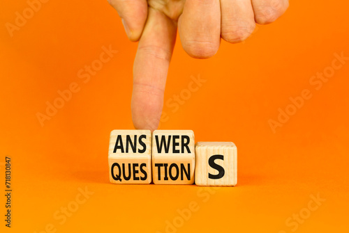 Q and A questions and answers symbol. Turned wooden cubes and changed the word questions to answers. Beautiful orange background, copy space. Business Q and A questions and answers concept. photo