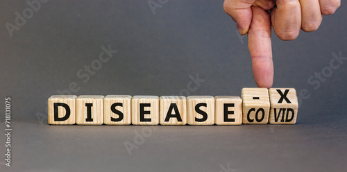 Disease X after covid symbol. Turned cubes and changed the word Disease COVID to Disease X. Beautiful grey table grey background. Doctor hand. Medical, Disease X after covid concept. Copy space.