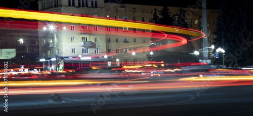 A photo using a slow shutter speed to capture the lights on a highway.