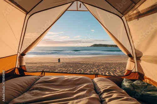 View from inside an open camping tent from the sleeping place to the beautiful sandy seaside sea ocean landscape. Concept of mountaineering, tourist recreation and sport