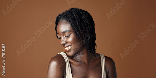 Face, beauty and aesthetic with funny black woman in studio isolated on brown background for wellness. Portrait, skincare and laughing for natural cosmetics or foundation with confident young person