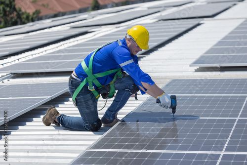 Engineer repair solar panel on the factory rooftop photo