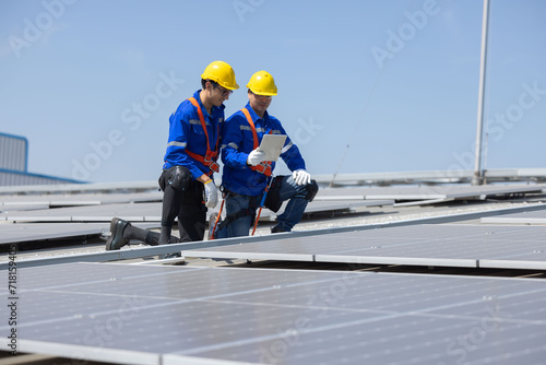 Caucasian engineer checking on solar panel on the rooftop