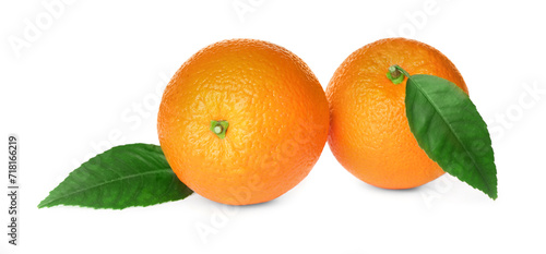 Fresh ripe oranges with green leaves on white background