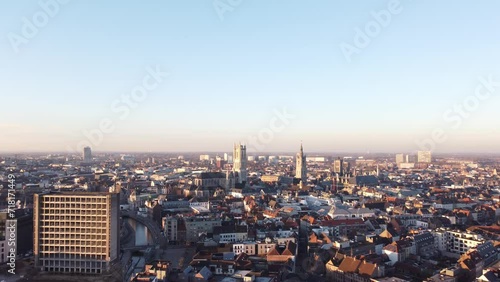 Aerial view of the city of Ghent at sunrise. Orange-yellow light illuminates the Belfry of Ghent. Dawn over the city in Flanders, Belgium photo