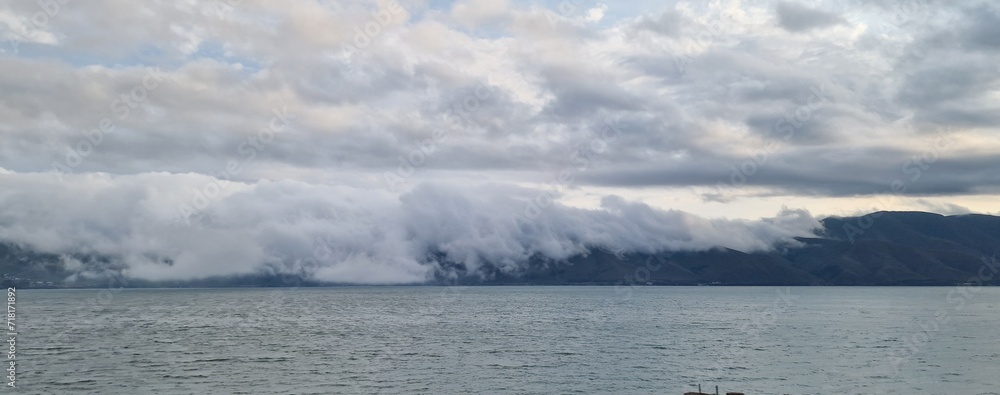 lake sevan in armenia and clouds falling over the mountains