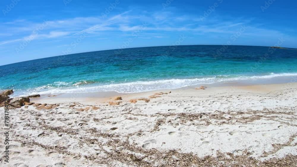 Walking by turquoise water in Is Arutas beach. Sardinia, Italy Walking by turquoise water in Is Arutas beach. Sardinia, Italy