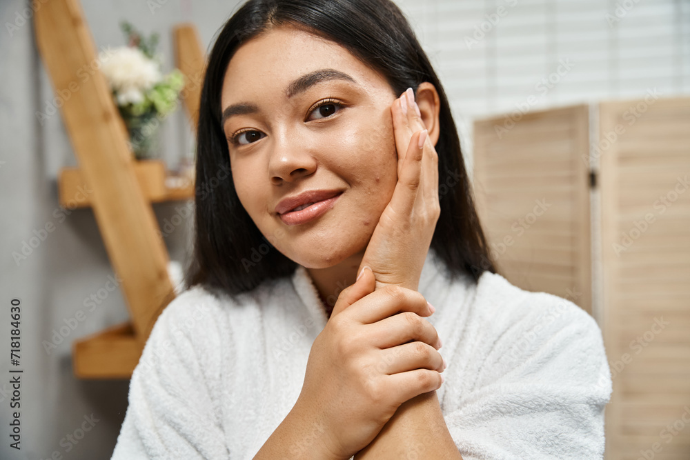 portrait of happy young asian woman with acne touching cheek and looking at camera, skin condition portrait of happy young asian woman with acne touching cheek and looking at camera, skin condition