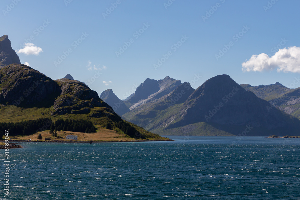 Chain of high mountains on the coast with dark water sea