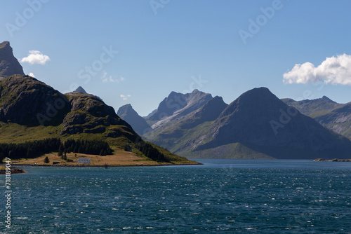 Chain of high mountains on the coast with dark water sea