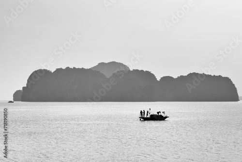 Fishermen in the boat in Ha Long Bay, Vietnam