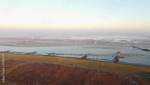 An aerial view of the Dutch flat landscape at the Ossenisse observation tower during the soft light of sunrise photo