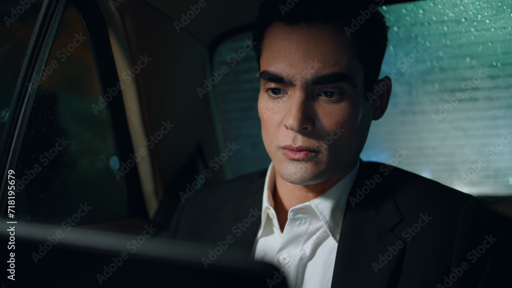 Business man reading tablet computer in car closeup. Manager looking pad device Business man reading tablet computer in car closeup. Manager looking pad device