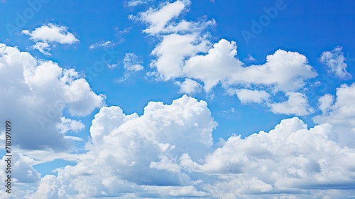 white fluffy clouds on the blue sky on a sunny day