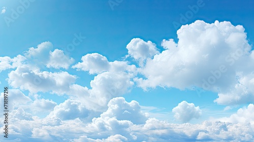 white fluffy clouds on the blue sky on a sunny day