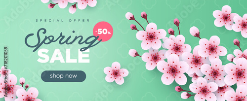 Spring sale long green banner with cherry blossom photo