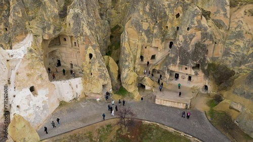 View of the Goreme Open Air Museum in Cappadocia, Turkey. This Unesco World Heritage site is an essential stop on any Cappadocian itinerary. Tourists visiting the historical site.