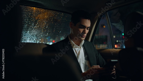 Focused manager working car closeup. Business man messaging cellphone at night © stockbusters