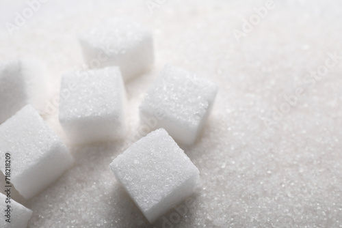 Different types of white sugar as background, closeup. Space for text