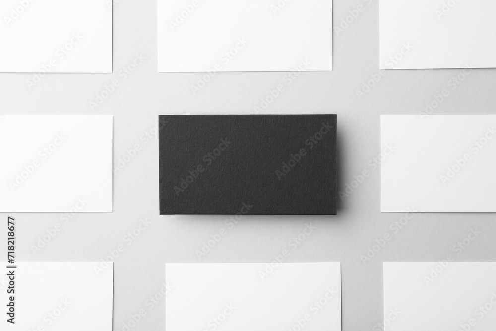 Blank black and white business cards on light background, flat lay. Mockup for design Blank black and white business cards on light background, flat lay. Mockup for design