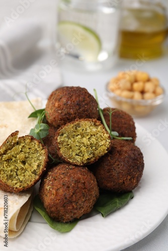 Delicious falafel balls and lavash on table