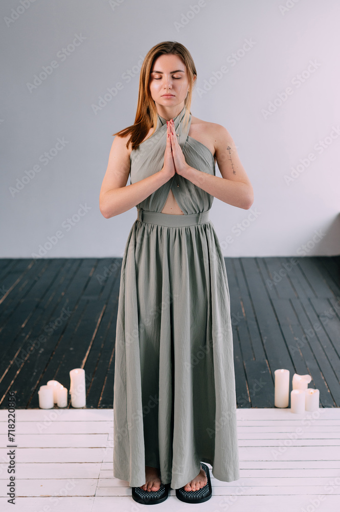 A young woman stands on the sadhu boards. Practice standing on nails. Full length portrait. A young woman stands on the sadhu boards. Practice standing on nails. Full length portrait.