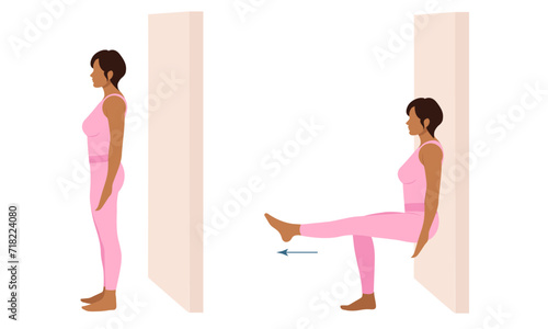 A woman does exercises near the wall. Wall Pilates.