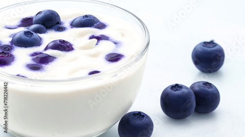 Tasty creamy Yogurt with blueberry, on white. Perfect for healthy breakfast or snack option