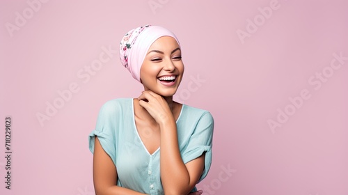 Studio portrait of a happy cancer patient against a pastel background. close up Middle-aged woman with cancer photo
