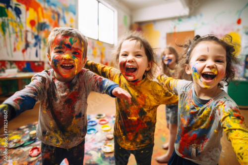 Children smeared with paints in an art school paint pictures