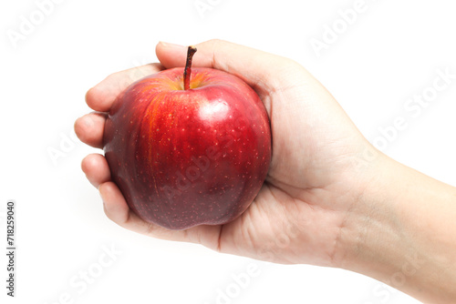 Hand holding fresh organic red apple delicious fruit isolated on white background clipping path