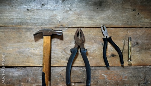 old pliers hammer and pincers on an old wooden workbench old work tools photo