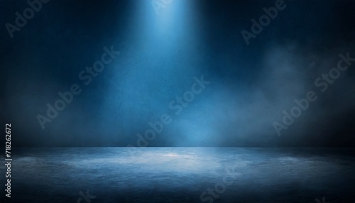 the dark stage shows dark blue background an empty dark scene neon light and spotlights the concrete floor and studio room with smoke float up the interior texture for display products