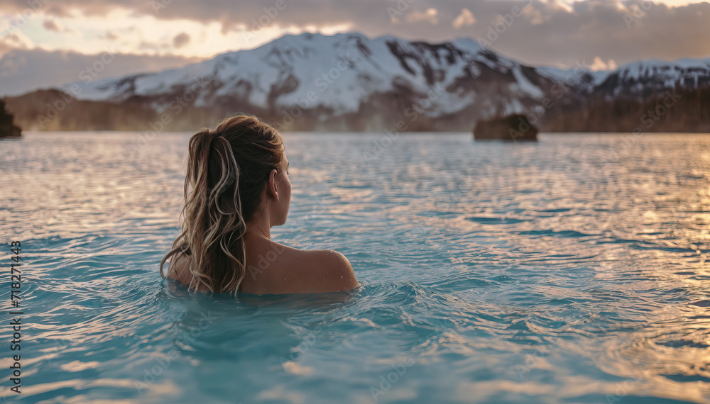 Pretty woman enjoying hot geothermal spa. Blue Lagoon in Iceland. Wellness, relaxation, rest and health care concept.