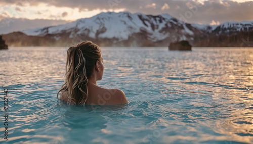 Pretty woman enjoying hot geothermal spa. Blue Lagoon in Iceland. Wellness, relaxation, rest and health care concept. © Shootdiem