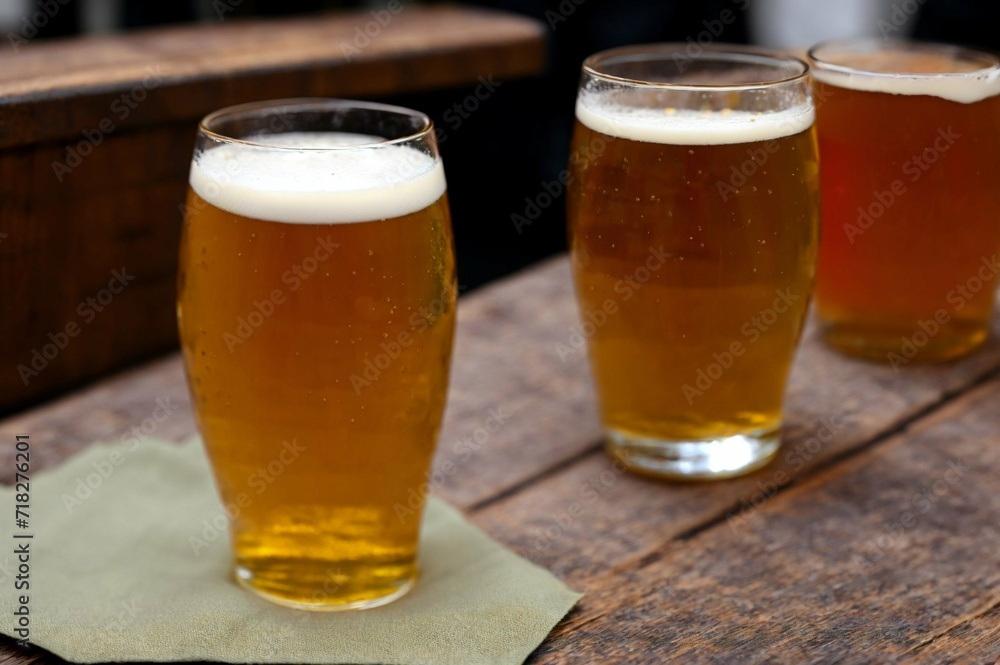 Glass of beer with steamed rice and parsley on wooden board Glass of beer with steamed rice and parsley on wooden board
