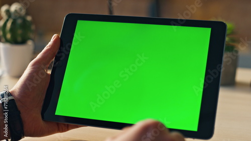 Hands touching mockup tablet searching information in internet indoors close up.