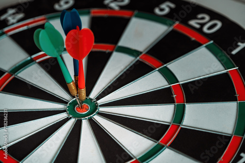 Concept of challenge in business marketing bullseye and intelligent customer reaching. The dart is the strategy or skill. The dartboard is the target or goal. uds