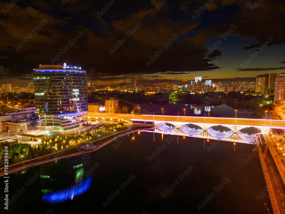 Yekaterinburg city and pond aerial panoramic view at summer or early autumn night. Night city in the early autumn or summer.