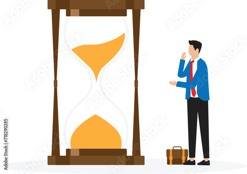 Wasting time waiting and never start new business, time fly or ineffective thinking or laziness concept, businessman sitting on time passing sandglass or hourglass.

