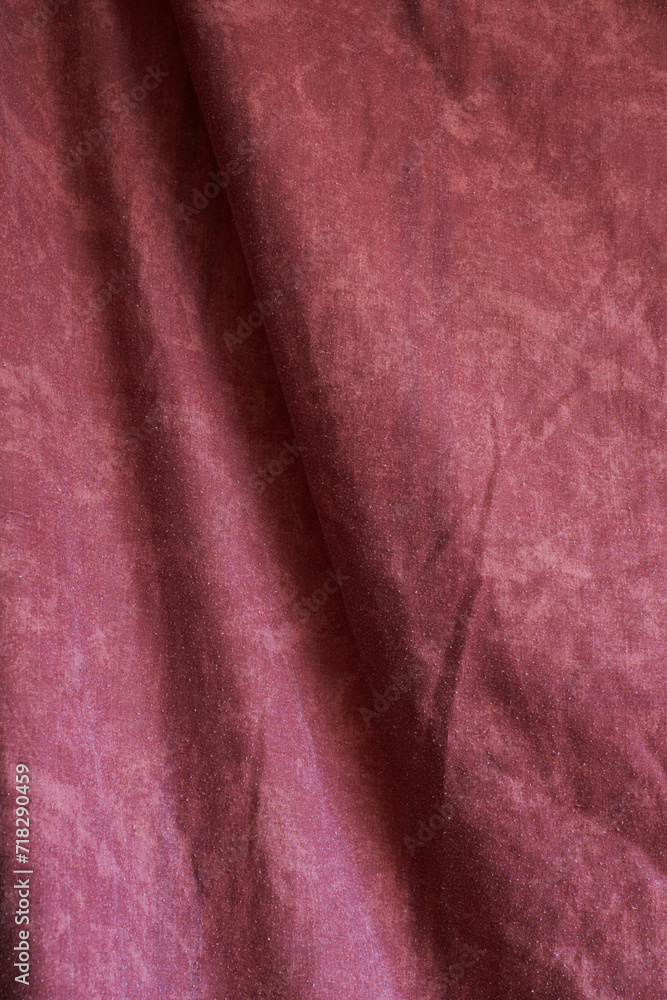Maroon color crumpled fabric background Maroon color crumpled fabric background