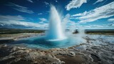  a geyser spewing water into the air from a pool of water in the middle of a field with a blue sky and white cloud filled with white clouds.