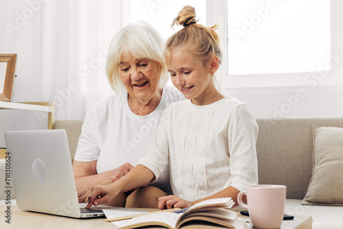 Selfie education video togetherness sofa granddaughter hugging grandmother bonding child smiling call family laptop © SHOTPRIME STUDIO