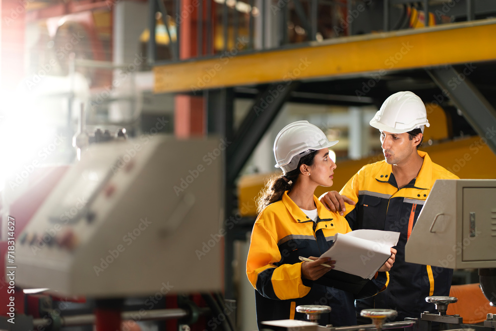 two professional engineer,worker,technician use clipboard discuss work, walk in steel metal manufacture factory plant industry. Black African American man and woman wear hard hat check quality machine two professional engineer,worker,technician use clipboard discuss work, walk in steel metal manufacture factory plant industry. Black African American man and woman wear hard hat check quality machine