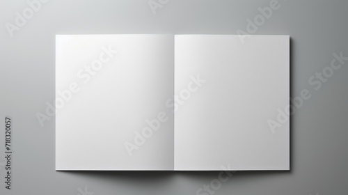  an open white book on a gray background with a shadow on the bottom of the book and a shadow on the bottom of the book.