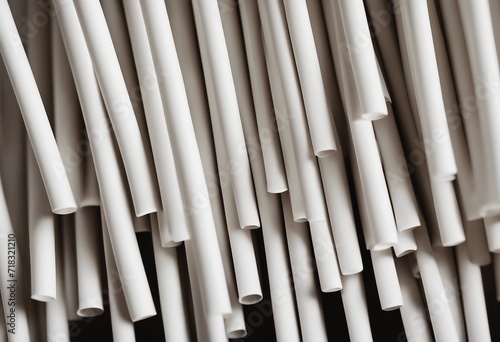 Close up on white paper straws facing upwards isolated on black background ecologically friendly